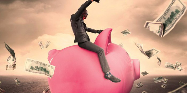 A business person riding a giant piggy bank