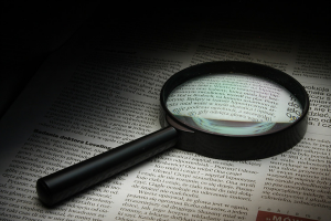 Magnifying glass on newspaper