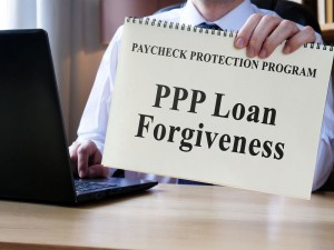 Person Holding PPP Loan Forgiveness Notebook