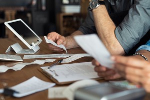 People Evaluating Paperwork at a Table